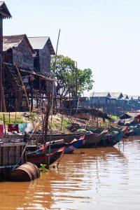 Traditional wooden boats await your Tonle Sap tour Siem Reap adventure