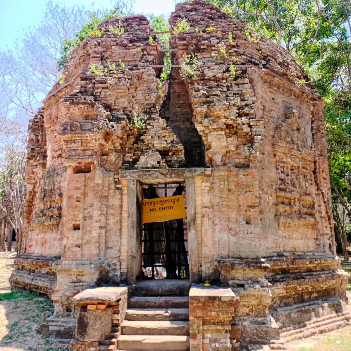 Weathered brick temple entrance at Sambor Prei Kuk with carved details and a preserved doorway, part of the Phnom Penh to Siem Reap road sightseeing day on this private Cambodia itinerary.